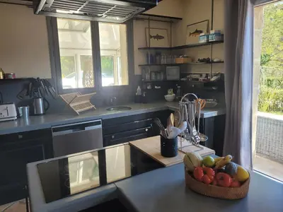 a kitchen with a bowl of fruit on a counter at Villa confortable avec jardin à Rognes – 200 m² in Rognes