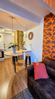 a living room with a couch and a kitchen at Duplex Aix Sunset Coeur centre historique in Aix-en-Provence