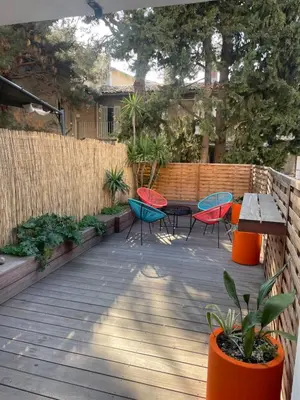 a patio with chairs and tables and a fence at Duplex Aix Sunset Coeur centre historique in Aix-en-Provence