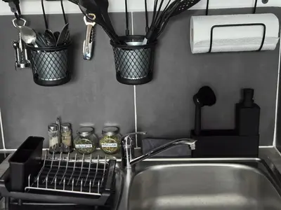 a kitchen sink with a dish drying rack and utensils at Studio Bleu Aix-en-Provence terrasse, piscine, parking in Aix-en-Provence