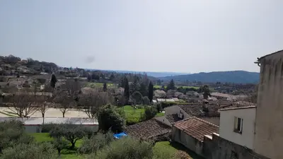 a view of a town with mountains in the background at Maison de charme in Pierrevert