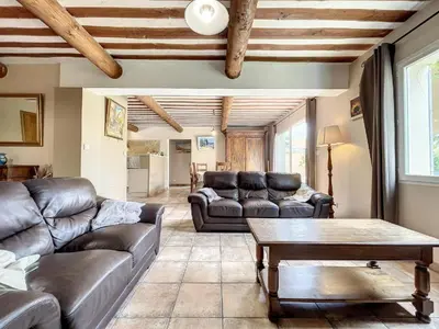 a living room with leather couches and a table at Maison LEA in Bédoin