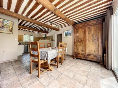 a kitchen and dining room with a table and chairs at Maison LEA in Bédoin