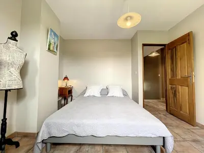 a bedroom with a large bed with white sheets at Maison LEA in Bédoin