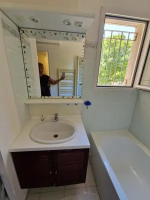 a man taking a picture of a bathroom with a sink at Studio DOUILLET in Aix-en-Provence