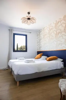 a bedroom with a large bed and a window at Maison en Provence avec piscine in Éguilles