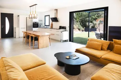 a living room with a couch and a table at Maison en Provence avec piscine in Éguilles