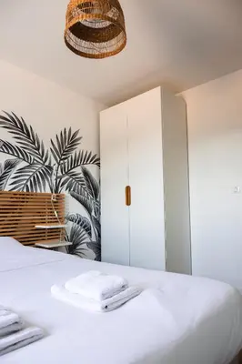 a bedroom with a white cabinet and a plant at Maison en Provence avec piscine in Éguilles
