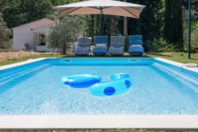 a book sitting on top of a blue camping chair at Maison en Provence avec piscine in Éguilles