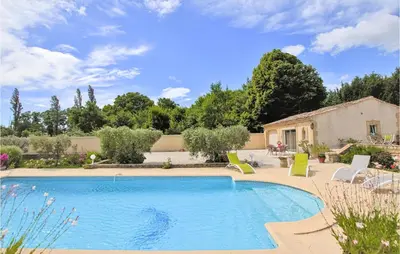 a swimming pool in a yard with chairs and a house at Beautiful Home In Lancon De Provence in Lançon-Provence