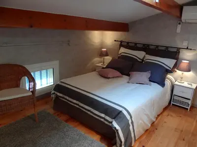 a bedroom with a large bed with two pillows at Duplex En Provence in Vedène