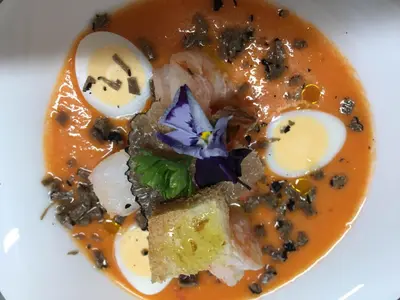 a plate of food with a bowl of soup at Auberge Les Olivades in Mallemort