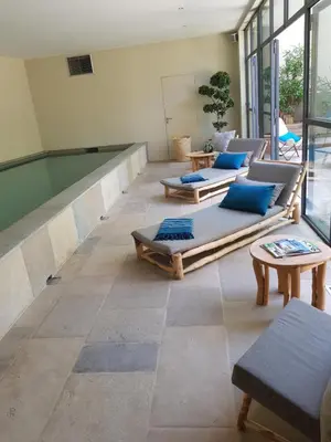 a room with couches and pillows on the floor at La Magnanerie de l'Isle B&B in LʼIsle-sur-la-Sorgue