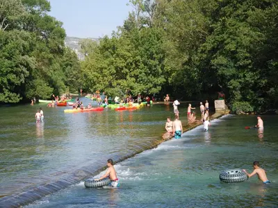 a group of people in the water in a river at Villa in Lubéron with Saltwater Pool in Apt