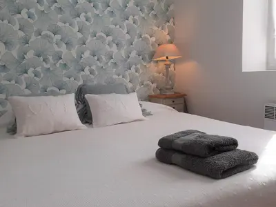 a bedroom with a bed with two towels on it at Le Mazet du Domaine in Gordes