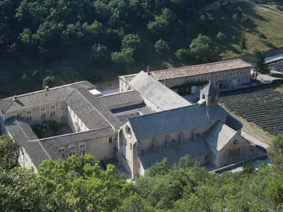 an aerial view of an old building with trees at Le Mazet du Domaine in Gordes