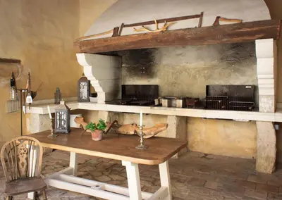 a kitchen with a wooden table in a room at Les Carmes and spa in Le Thor
