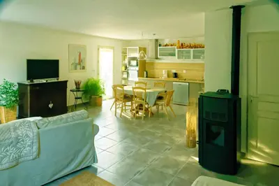 a living room and kitchen with a couch and a table at La Rousse in Roussillon