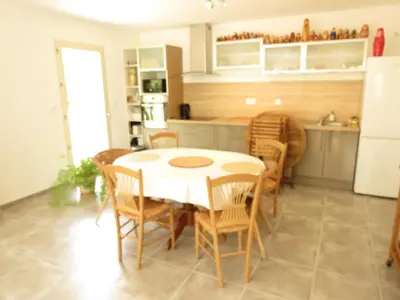 a kitchen and dining room with a table and chairs at La Rousse in Roussillon