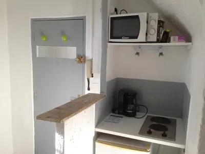 a small kitchen with a microwave and a stove at Appartement L'Atypique in Pertuis