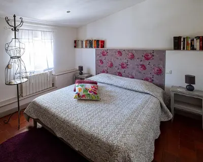 a bedroom with a bed and a lamp in it at L'Escarpolette in Saint-Saturnin-les-Apt