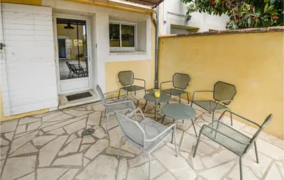 a group of chairs and a table on a patio at Awesome Home In Chateuneuf De Gadagne in Châteauneuf-de-Gadagne