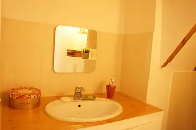 a bathroom with a sink and a mirror at Longo Mai in Apt