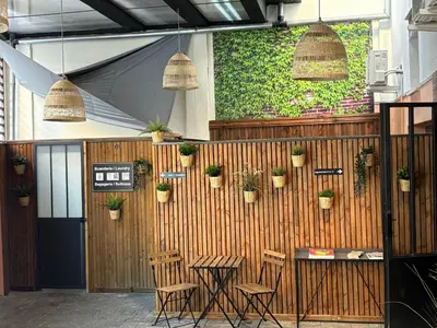 a restaurant with a wooden wall with potted plants on it at Casa Hotel in Aix-en-Provence
