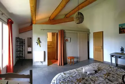 a bedroom with a large bed in a room at La Sarriette - Chambres d'hôtes et gîte d'étape à Eygalières in Eygalières