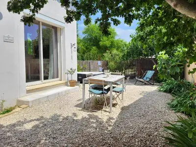 a patio with a table and chairs in a yard at Mas Nina Rosa in Mazan