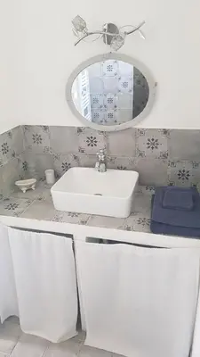 a bathroom with a white sink and a mirror at Mas Nina Rosa in Mazan