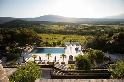a view of a swimming pool with mountains in the background at Hôtel La Maison de Crillon in Crillon-le-Brave