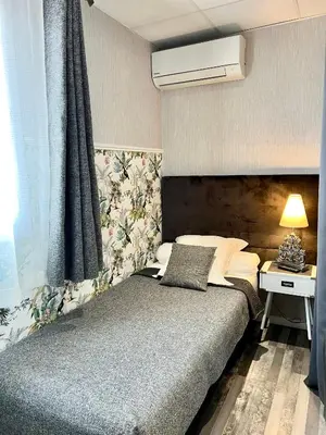 a bedroom with a bed and a window at Hôtel de Charme Le Provence in Salon-de-Provence