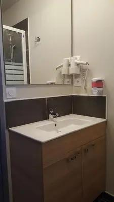 a bathroom with a sink and a mirror at Hotel Belvue in Sault-de-Vaucluse