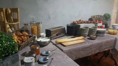 a table topped with a table with food on it at Hotel Belvue in Sault-de-Vaucluse