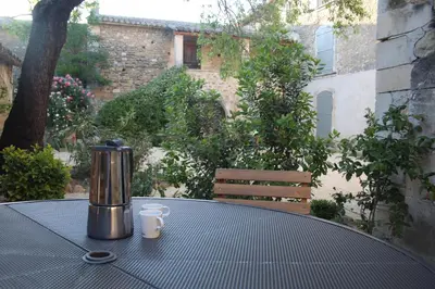 a table with a coffee maker and two cups on it at Les Guillaume Rey in Oppède