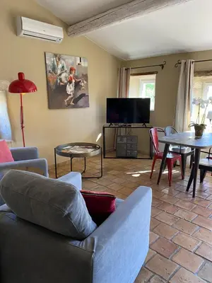 a living room with a couch and a table at Mas Serena in Ménerbes