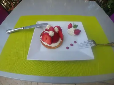 a plate with a dessert with strawberries and a fork at L'Aiguebelle in Céreste