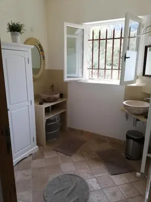a bathroom with two sinks and a window at Mas Saint Louis in Saignon