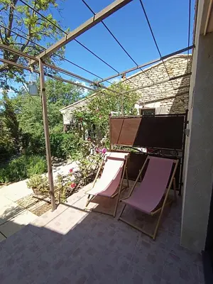 two chairs and a table on a patio at Mas Auroma in Murs