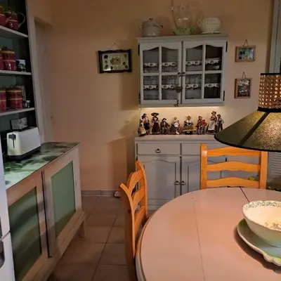a kitchen with a table and chairs in a kitchen at Les Cerises in Saint-Saturnin-les-Apt