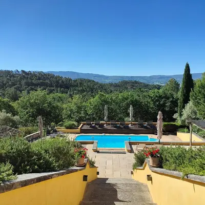 a resort with a swimming pool with a view at Le Chant du Coeur in Roussillon