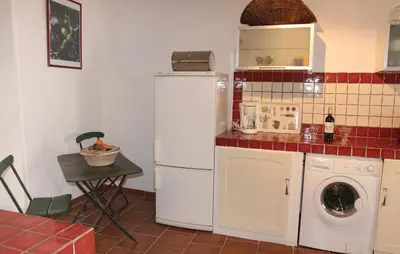 a kitchen with a white refrigerator and a washing machine at Stunning Home In Reillanne With Wifi in Reillanne