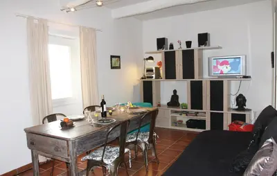 a living room with a wooden table and chairs at Stunning Home In Reillanne With Wifi in Reillanne