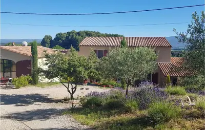 a view of a house with trees and flowers at 2 Bedroom Stunning Home In Apt in Apt