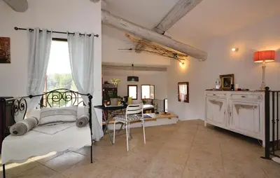 a bedroom with a bed and a table and a window at 2 Bedroom Stunning Home In Apt in Apt