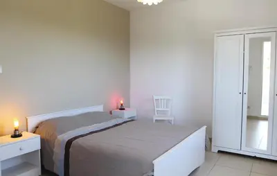 a bedroom with a bed and a chair and a window at 4 Bedroom Awesome Home In Apt in Apt
