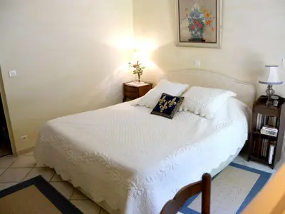a bedroom with a white bed with a pillow on it at Les chambres d'Adeline - B&B in Murs