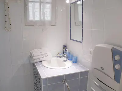 a white bathroom with a sink and a mirror at Les chambres d'Adeline - B&B in Murs