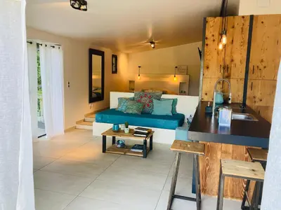 a living room with a couch and a table at Le Nid de la Huppe in Noves